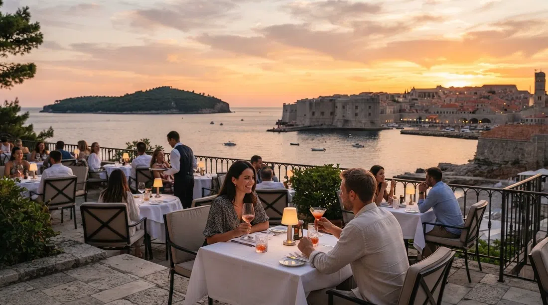 the Abakus Piano Bar terrace at Hotel Excelsior at sunset, sea-view tables with the walls and Lokrum beyond